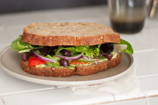 sandwich with avocado, pesto, roasted red bell pepper, olives and spring mix sandwich with avocado, pesto, roasted red bell pepper, olives and spring mix