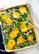 orange arugula salad with goat cheese, almonds and radishes