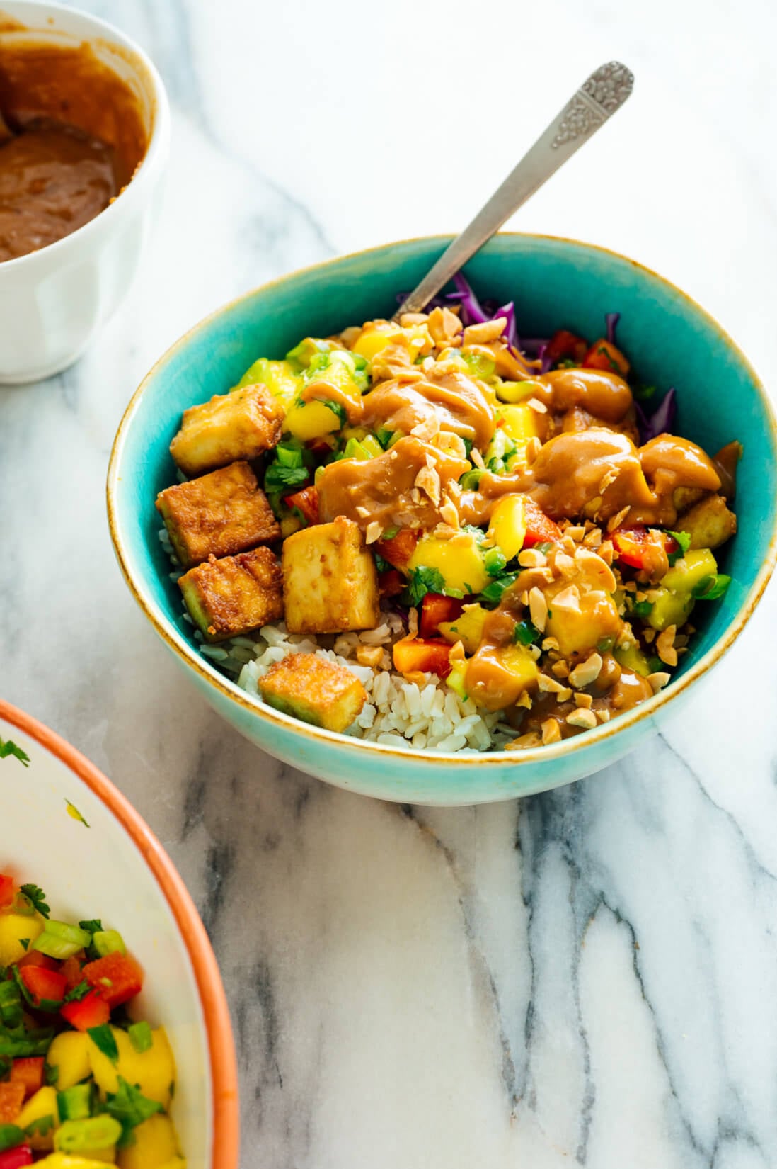 tofu and rice bowls with mango salsa and peanut sauce