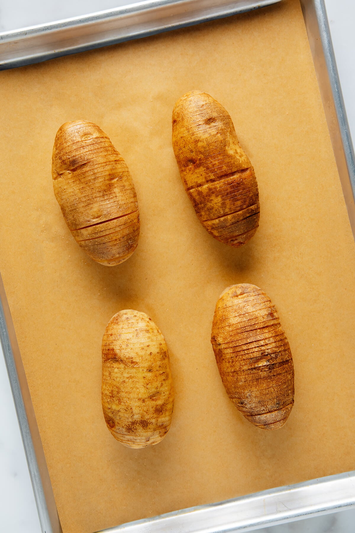 Hasselback potatoes before baking