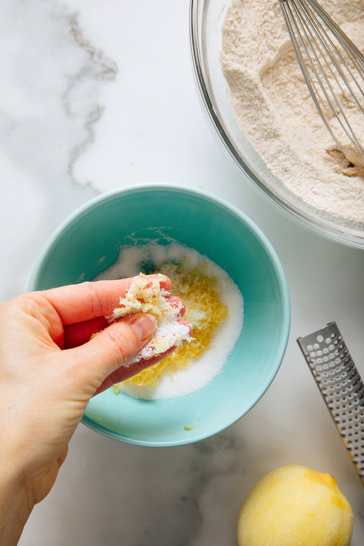 pressing lemon zest into sugar